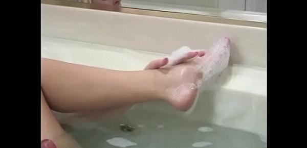  Stunning blonde Cailey Taylor with big boobs is fond of having a lark with her feet before playing with big pink dildo in hot tub